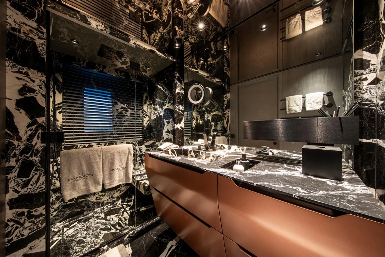 A luxurious bathroom with elegant marble finishes and modern fixtures. aboard PACIFIC PEARL Yacht for Sale