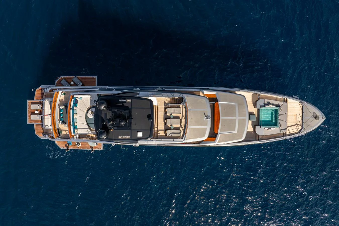 A stunning aerial view of a luxurious yacht cruising on the deep blue sea. aboard PACIFIC PEARL Yacht for Sale