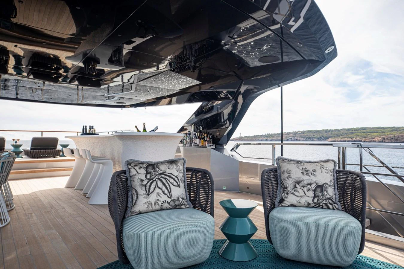 The aft deck offers a luxurious outdoor seating area with stylish furniture and a bar, perfect for relaxation and entertainment. aboard PACIFIC PEARL Yacht for Sale
