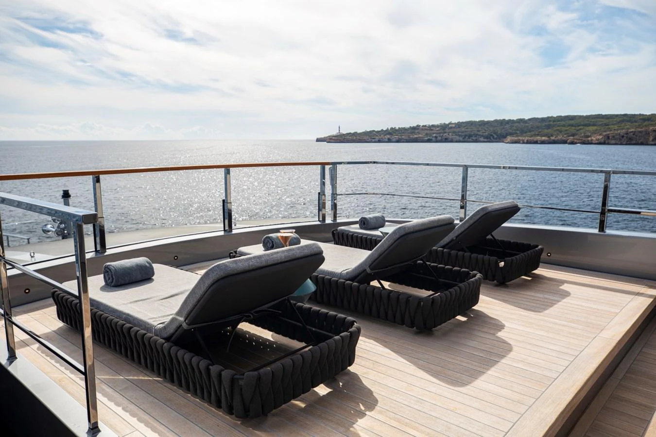 The sundeck features luxurious sun loungers with a stunning ocean view. aboard PACIFIC PEARL Yacht for Sale