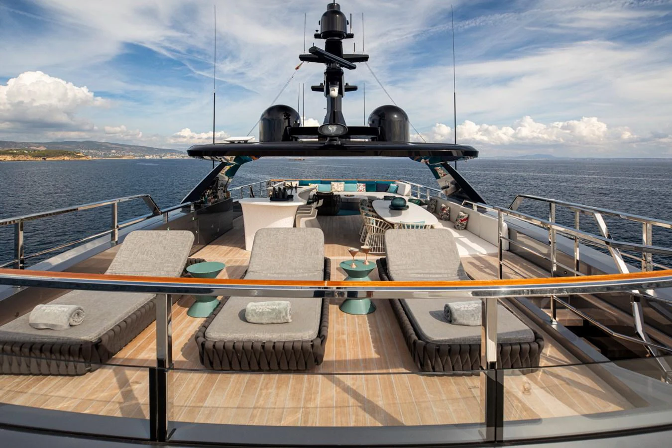 The sundeck offers a luxurious space with sun loungers and a stunning view of the sea. aboard PACIFIC PEARL Yacht for Sale