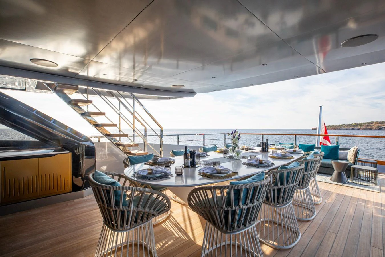 The aft deck features an elegant dining area with a stunning view of the sea. aboard PACIFIC PEARL Yacht for Sale