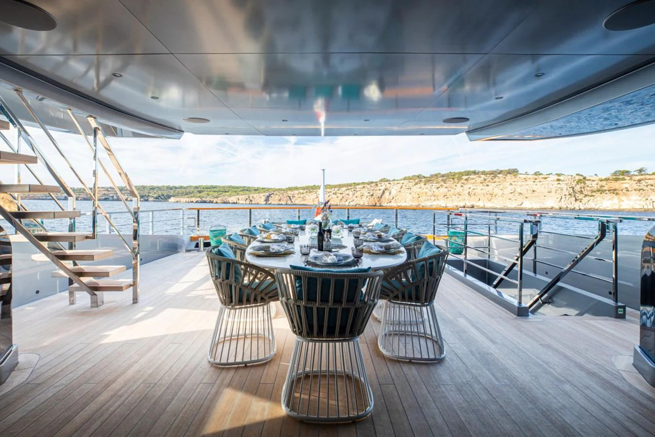 The aft deck features an elegant dining area with a stunning view of the sea. aboard PACIFIC PEARL Yacht for Sale