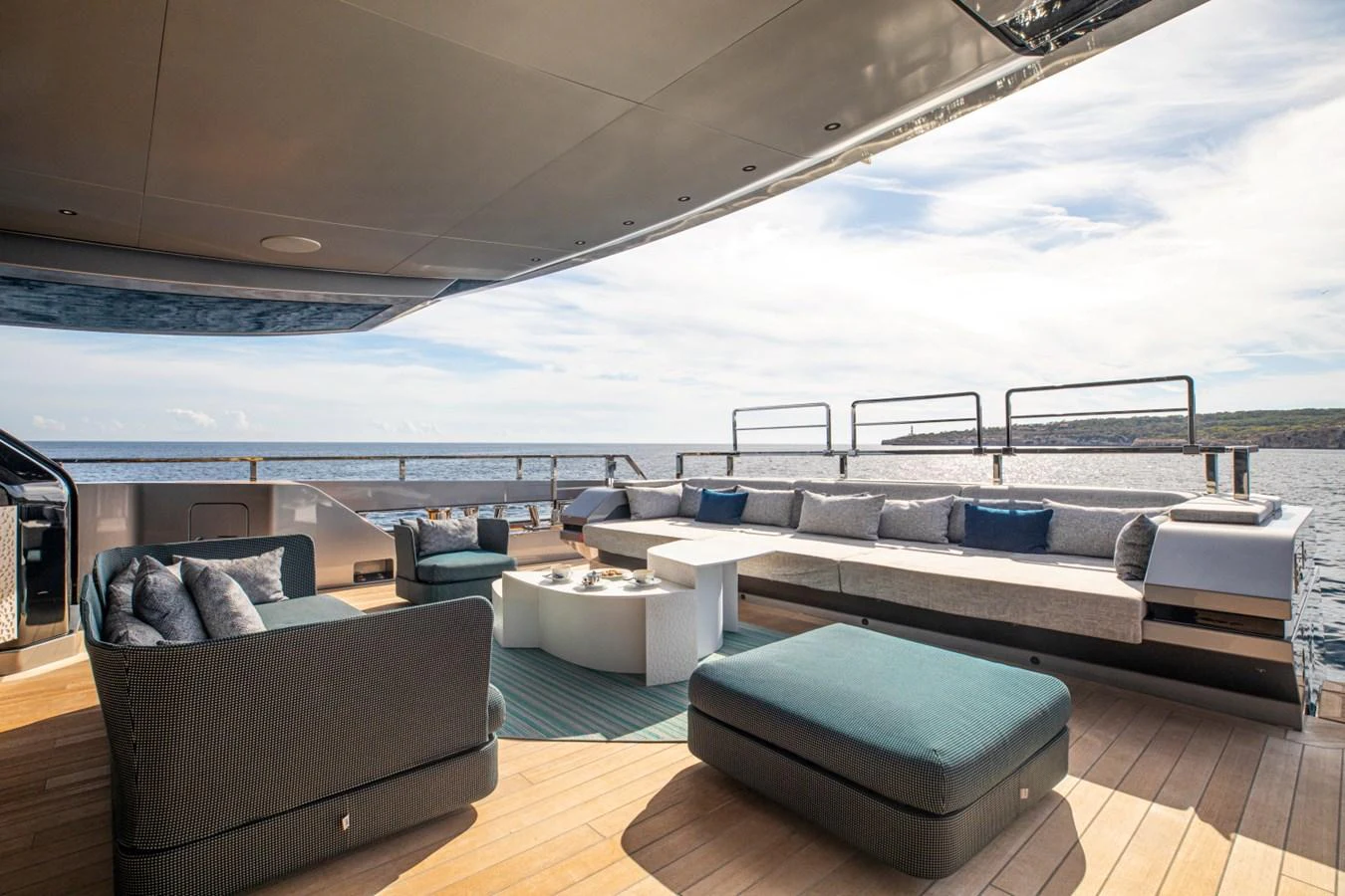 The aft deck offers a spacious and luxurious outdoor seating area with stunning ocean views. aboard PACIFIC PEARL Yacht for Sale