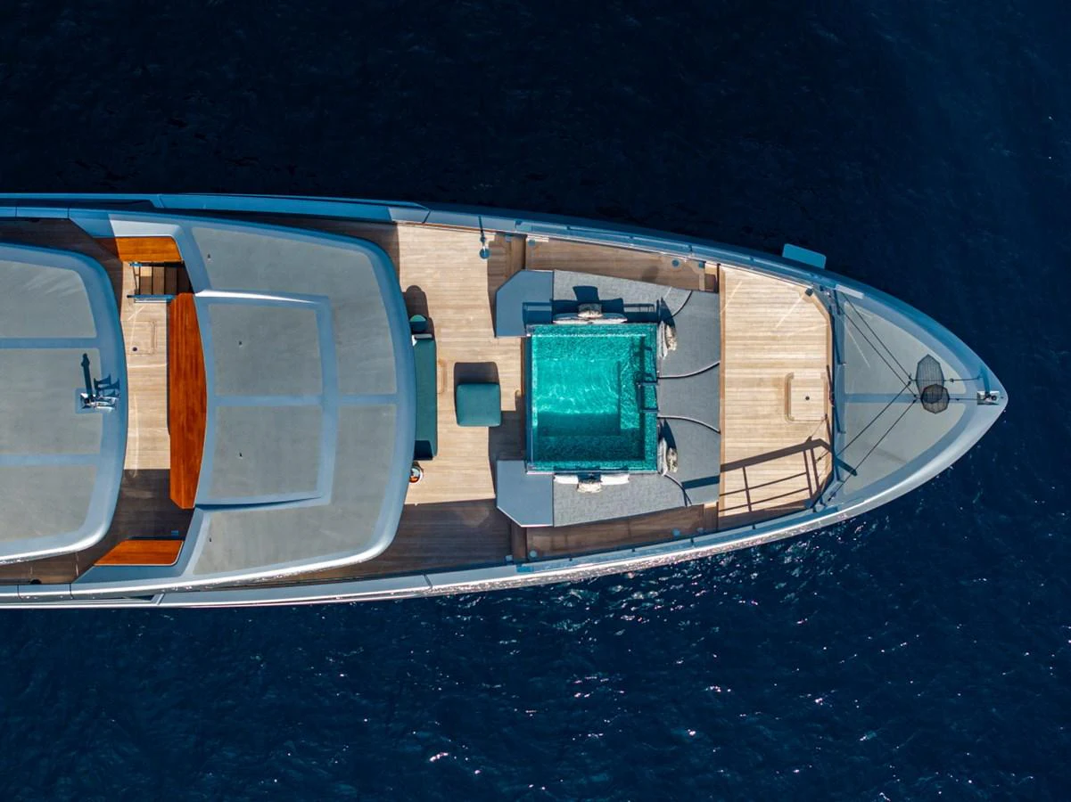 The foredeck of this yacht features a luxurious pool surrounded by ample lounging space. aboard PACIFIC PEARL Yacht for Sale