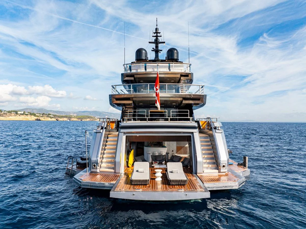The yacht's aft deck showcases a luxurious lounging area with stunning views of the open sea. aboard PACIFIC PEARL Yacht for Sale