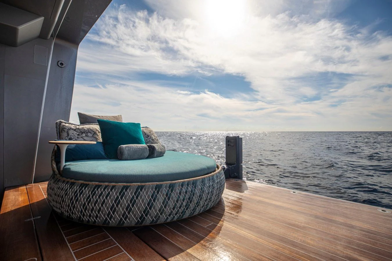 A luxurious circular sunbed on the aft deck offers a perfect spot to relax and enjoy the ocean view. aboard PACIFIC PEARL Yacht for Sale