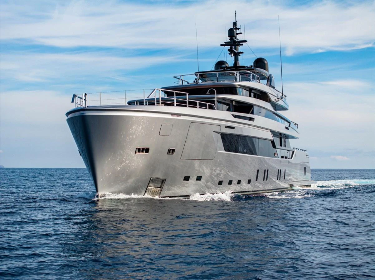 A sleek and modern yacht cruising on calm waters under a clear sky. aboard PACIFIC PEARL Yacht for Sale