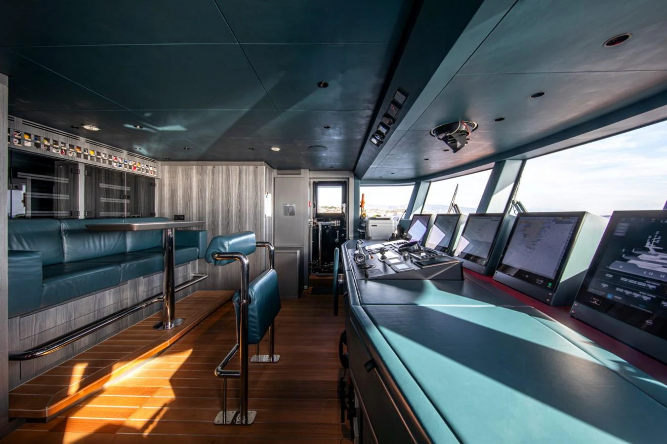 The helm station features advanced navigation equipment and comfortable seating, offering a commanding view for the captain. aboard PACIFIC PEARL Yacht for Sale
