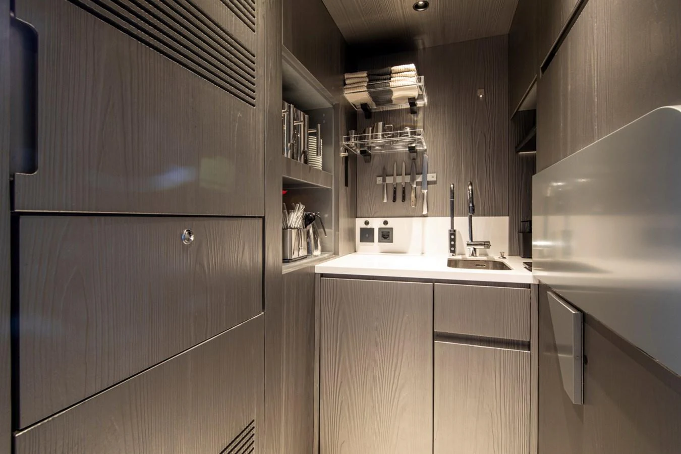The yacht's galley features sleek cabinetry and modern appliances for a functional and stylish cooking space. aboard PACIFIC PEARL Yacht for Sale