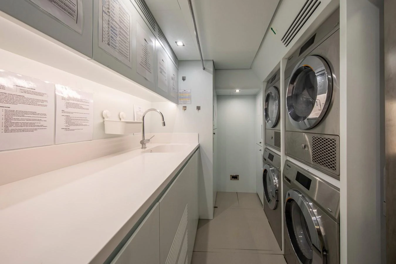 The yacht's laundry room is equipped with modern appliances and ample counter space. aboard PACIFIC PEARL Yacht for Sale