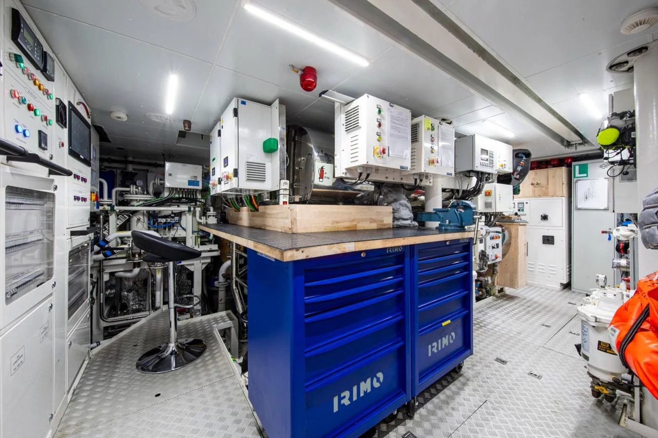 The engine room is equipped with advanced machinery and organized workspaces, ensuring efficient yacht operations. aboard PACIFIC PEARL Yacht for Sale