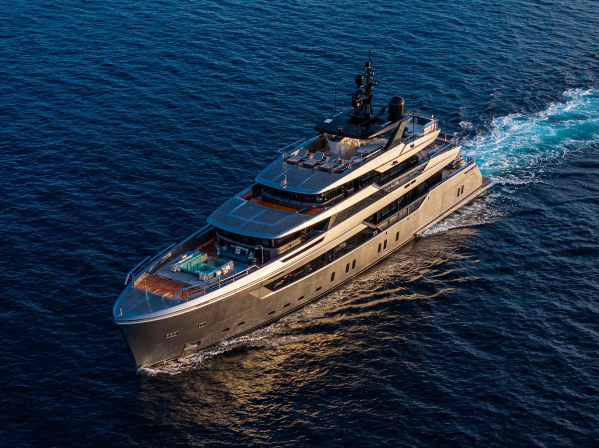 A luxurious yacht cruising through the open sea, showcasing its sleek design and spacious decks. aboard PACIFIC PEARL Yacht for Sale