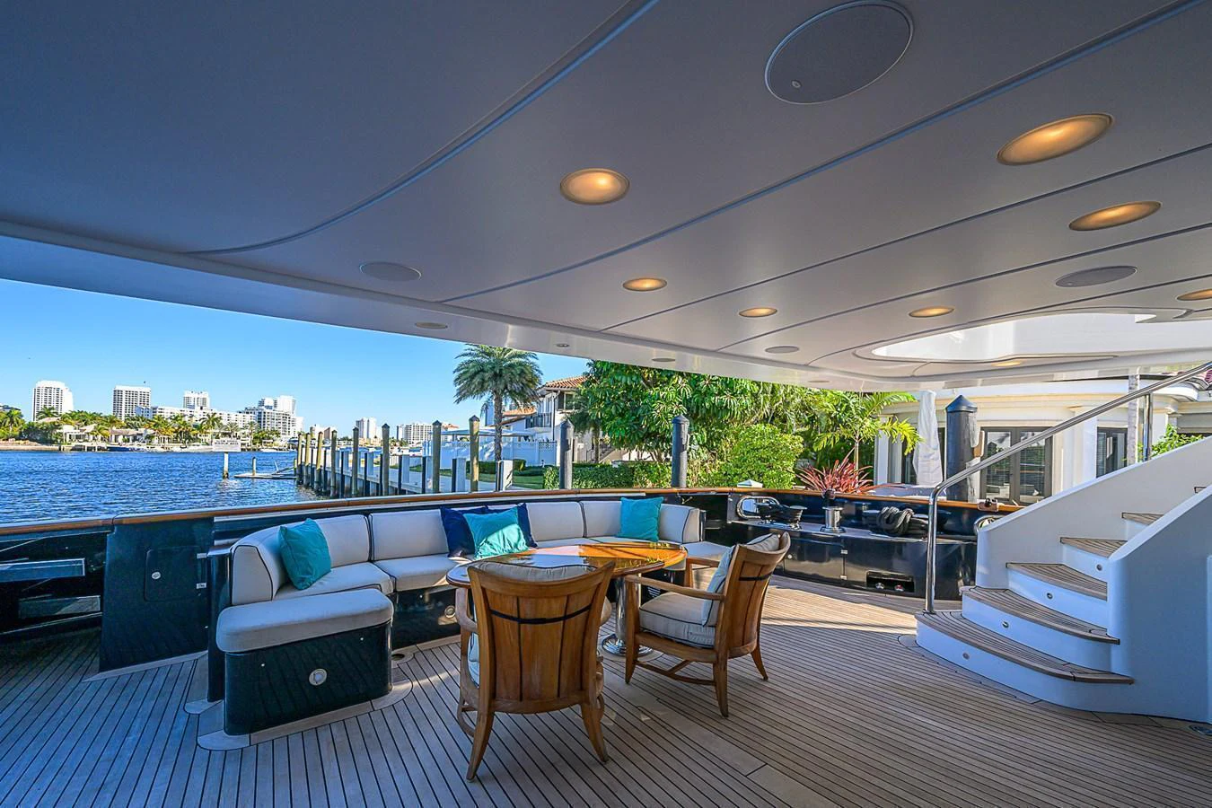 The aft deck offers a spacious and inviting area for relaxation and socializing with a stunning waterfront view. aboard SEASCAPE V Yacht for Sale