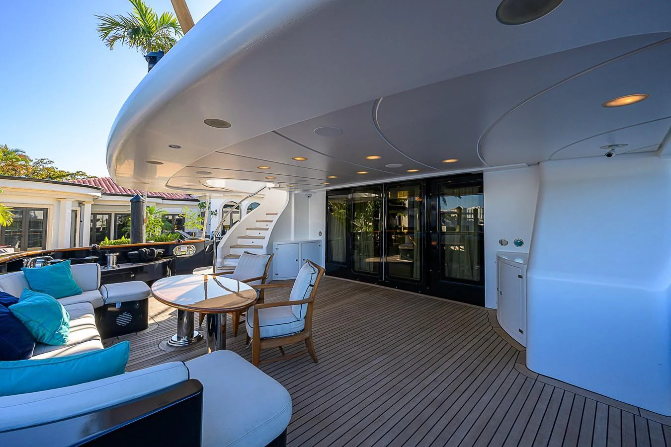 The aft deck features a spacious seating area with elegant furnishings and a view of the surrounding scenery. aboard SEASCAPE V Yacht for Sale