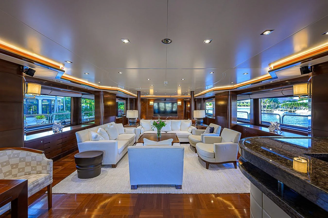 The yacht's salon features luxurious seating with ample natural light and elegant decor. aboard SEASCAPE V Yacht for Sale