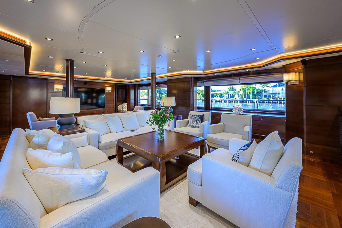 The salon features luxurious seating with ample natural light and elegant wooden accents. aboard SEASCAPE V Yacht for Sale