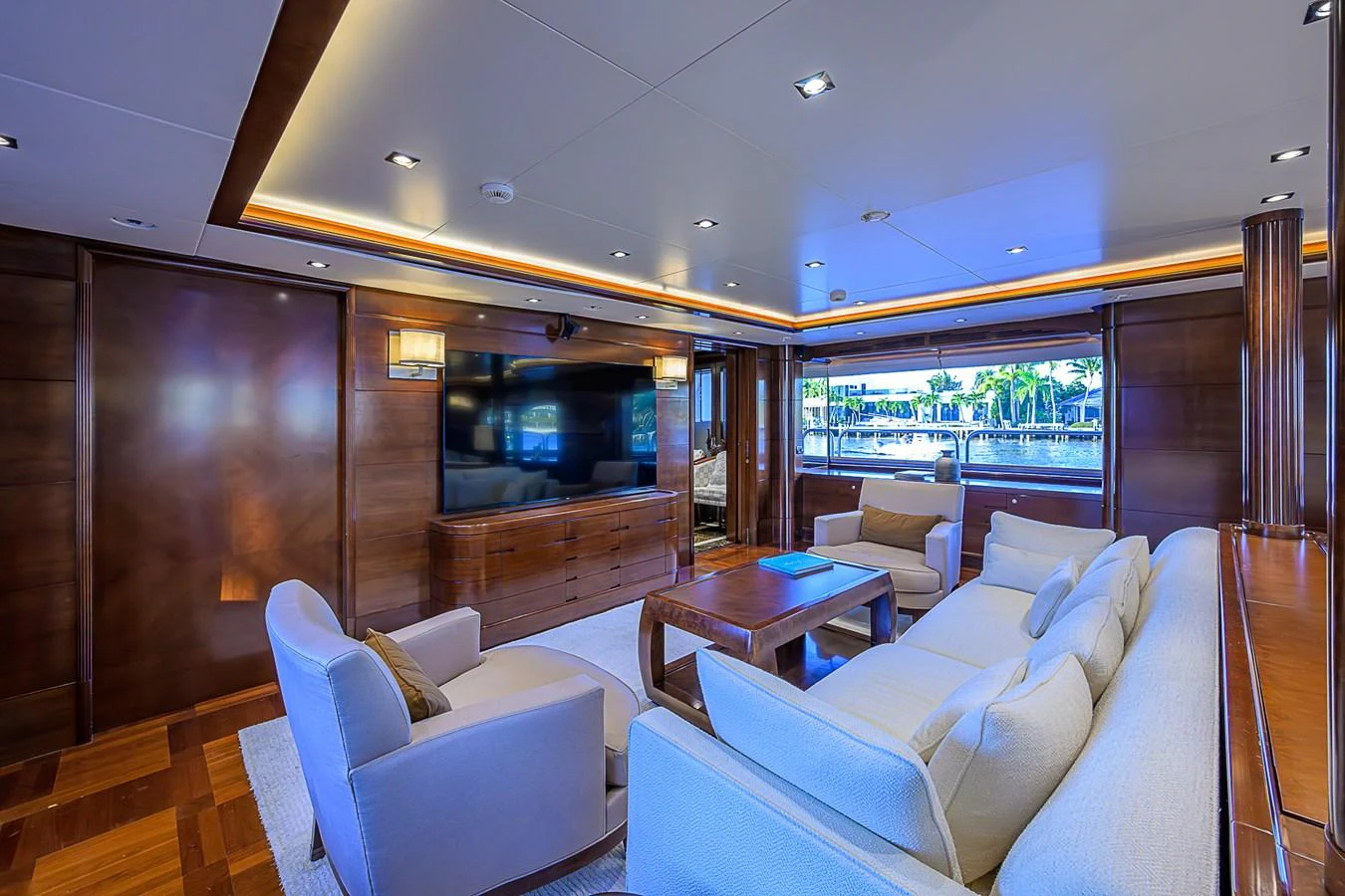 The salon features luxurious seating with a large window offering scenic views. aboard SEASCAPE V Yacht for Sale