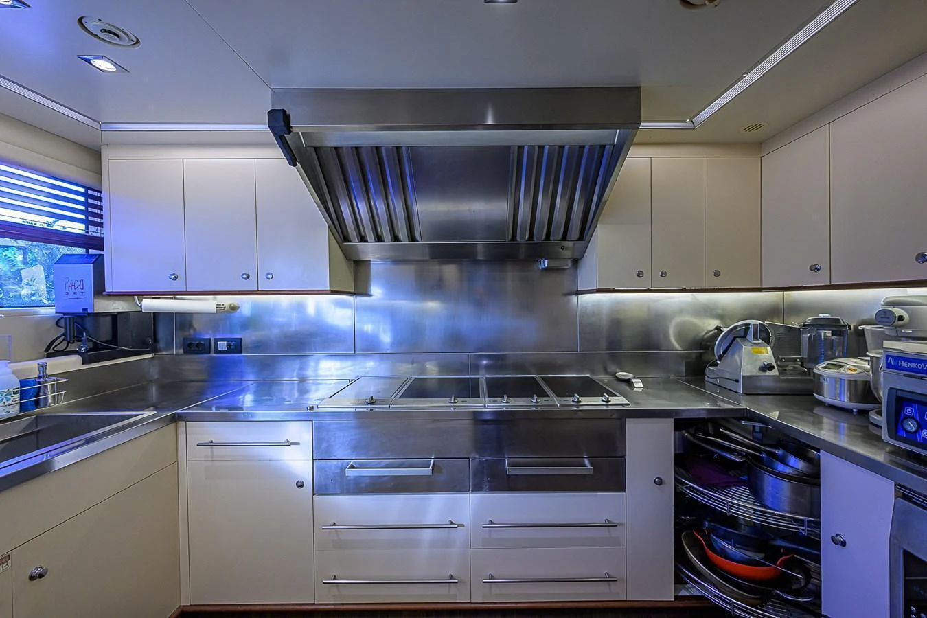 A modern galley equipped with stainless steel appliances and ample storage space. aboard SEASCAPE V Yacht for Sale