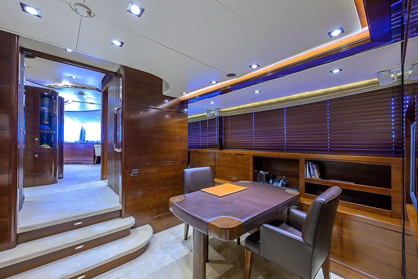 The yacht's office features elegant wood paneling, plush seating, and ample workspace for productivity at sea. aboard SEASCAPE V Yacht for Sale
