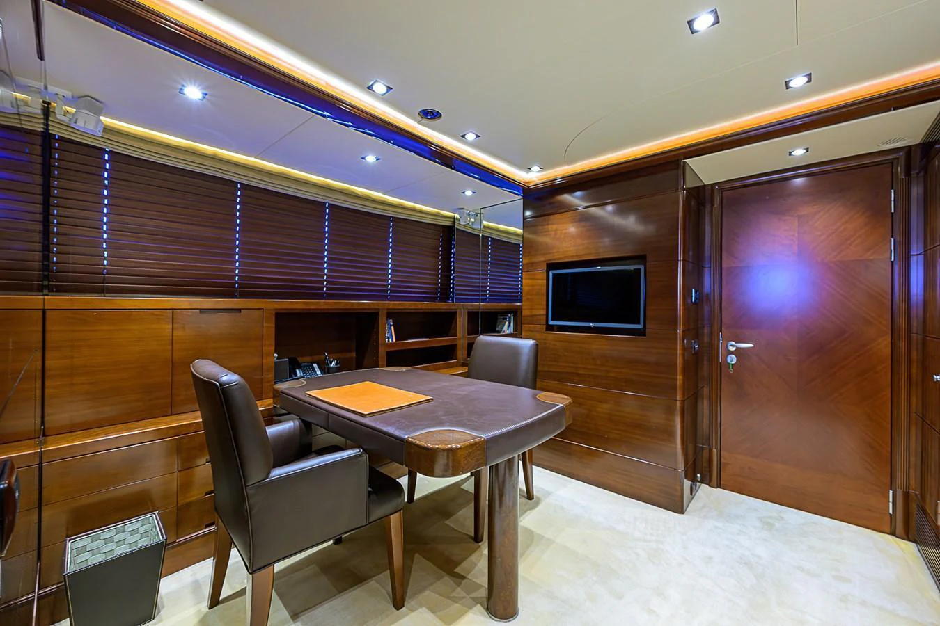 The yacht's office features a sophisticated design with rich wood paneling and modern lighting. aboard SEASCAPE V Yacht for Sale