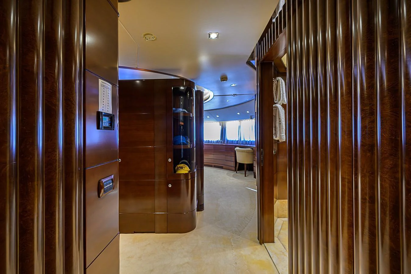 The yacht's interior features a luxurious hallway with rich wood paneling and plush carpeting. aboard SEASCAPE V Yacht for Sale