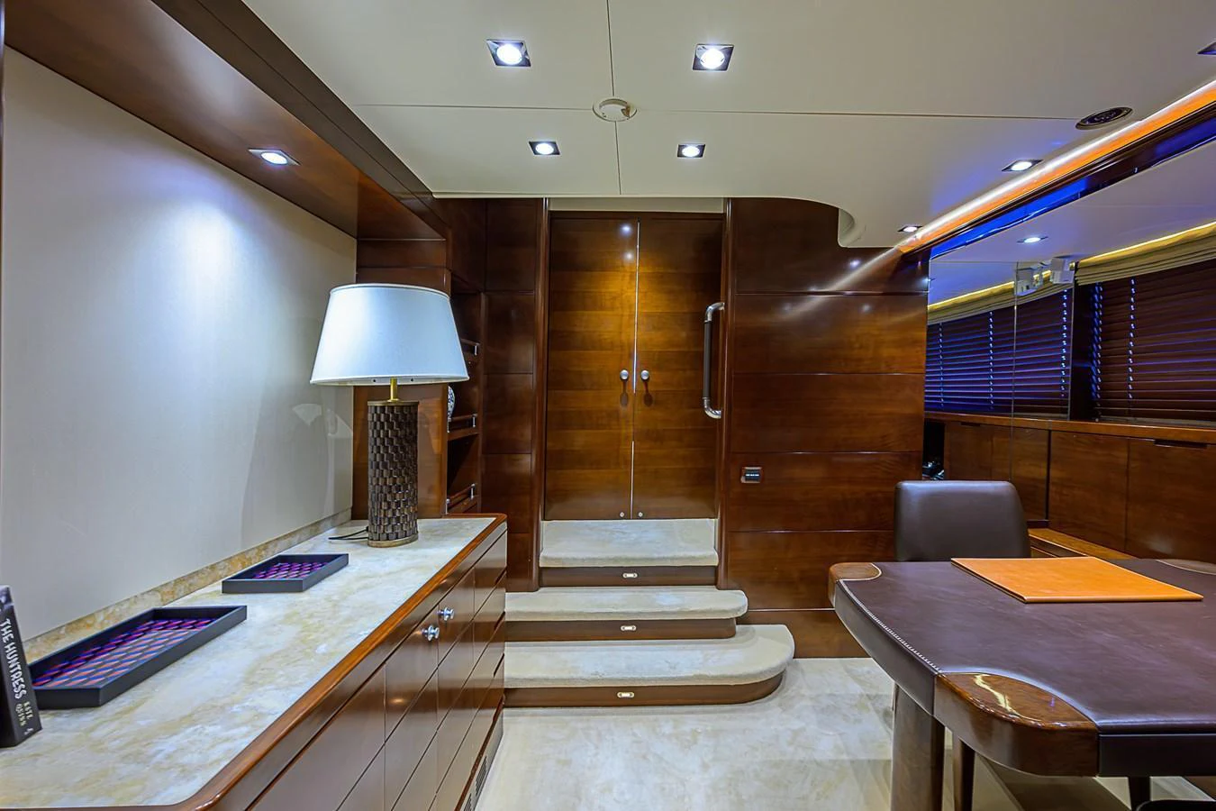 The yacht's interior features a luxurious and modern design with warm wood finishes and elegant lighting. aboard SEASCAPE V Yacht for Sale
