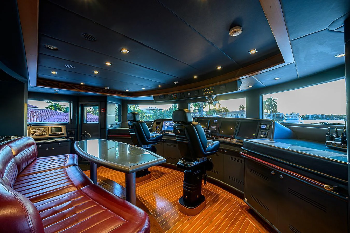 The helm station features luxurious seating and advanced navigation equipment, offering a commanding view of the surroundings. aboard SEASCAPE V Yacht for Sale