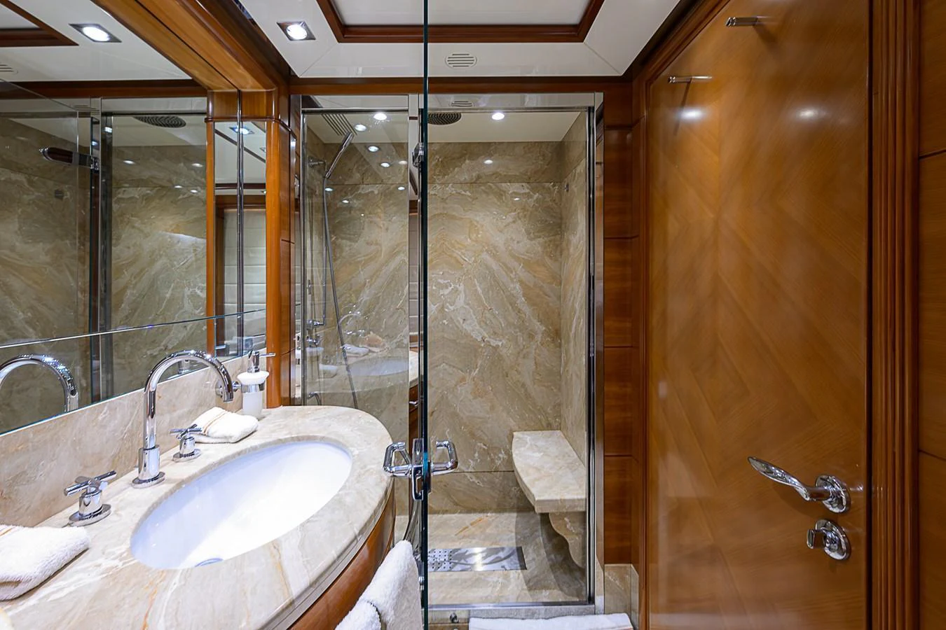 The yacht's bathroom features luxurious marble surfaces and elegant wood finishes. aboard SEASCAPE V Yacht for Sale