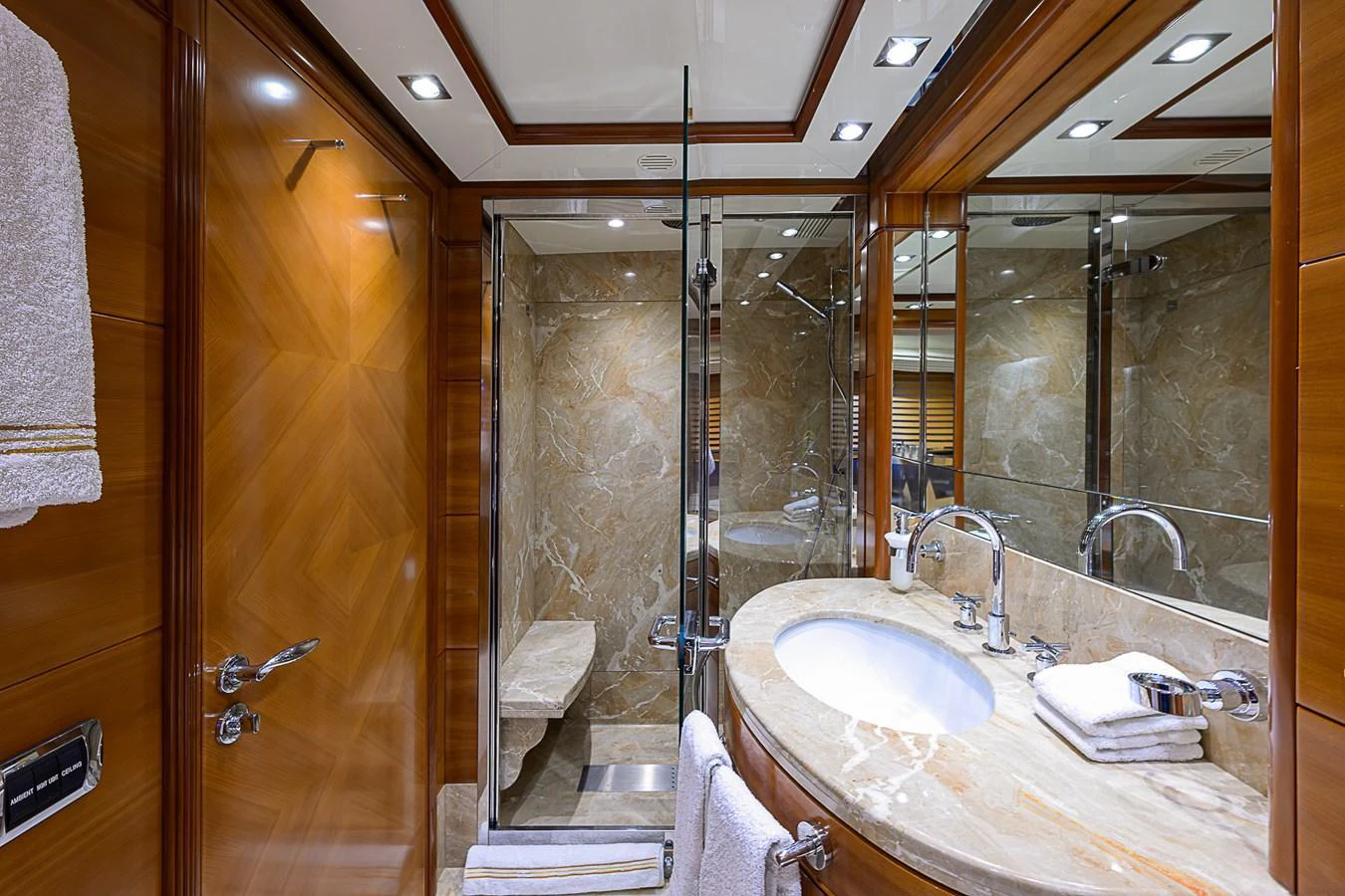 The yacht's bathroom features luxurious marble surfaces and elegant wooden accents. aboard SEASCAPE V Yacht for Sale