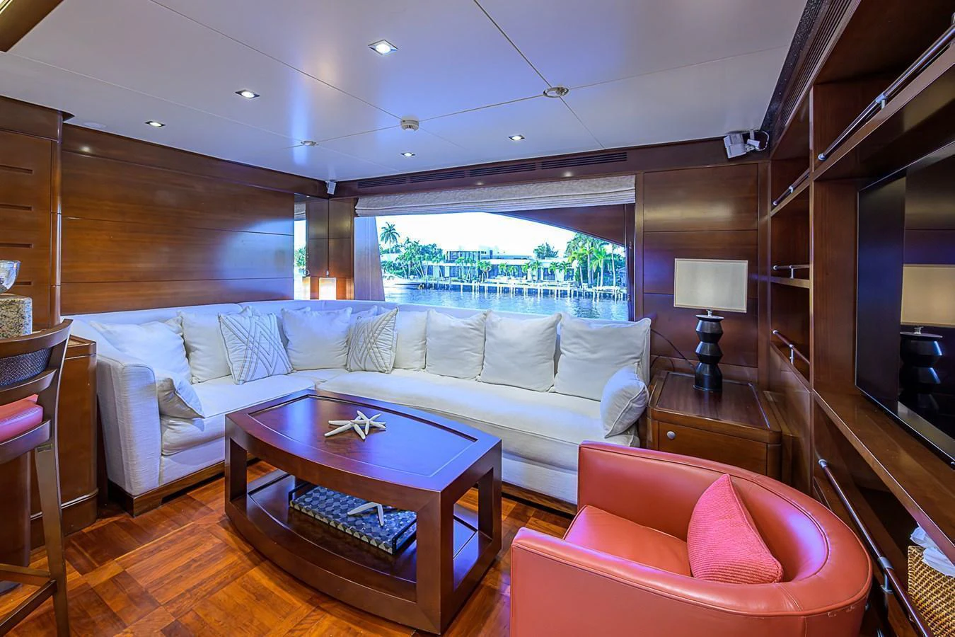 The salon features a comfortable seating area with a large window offering scenic views. aboard SEASCAPE V Yacht for Sale
