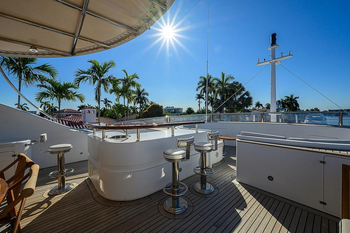 The sundeck offers a luxurious space with bar seating and panoramic views under the sun. aboard SEASCAPE V Yacht for Sale