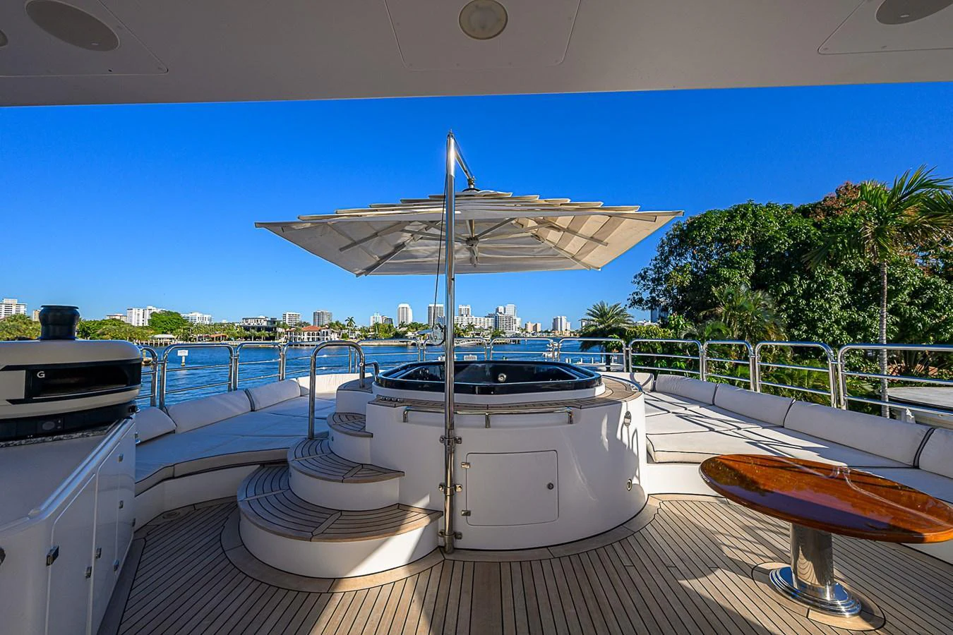 The sundeck features a luxurious hot tub with a large parasol, offering stunning views of the surrounding waters. aboard SEASCAPE V Yacht for Sale