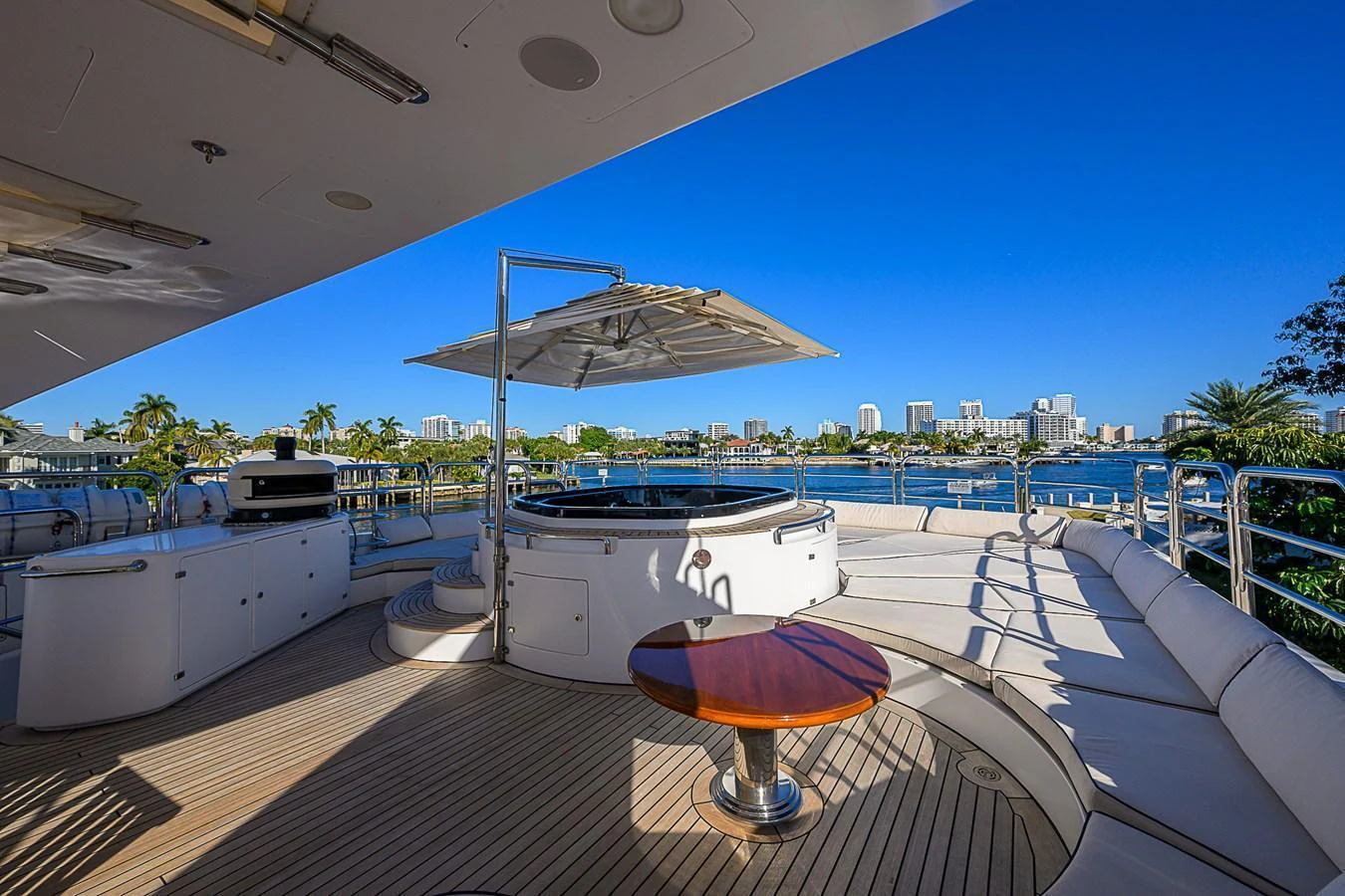 The sundeck features a luxurious hot tub with ample seating and stunning waterfront views. aboard SEASCAPE V Yacht for Sale