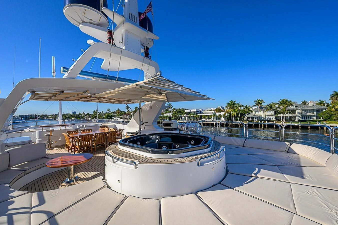 The sundeck features a luxurious hot tub surrounded by ample seating and a dining area, perfect for relaxation and entertainment. aboard SEASCAPE V Yacht for Sale