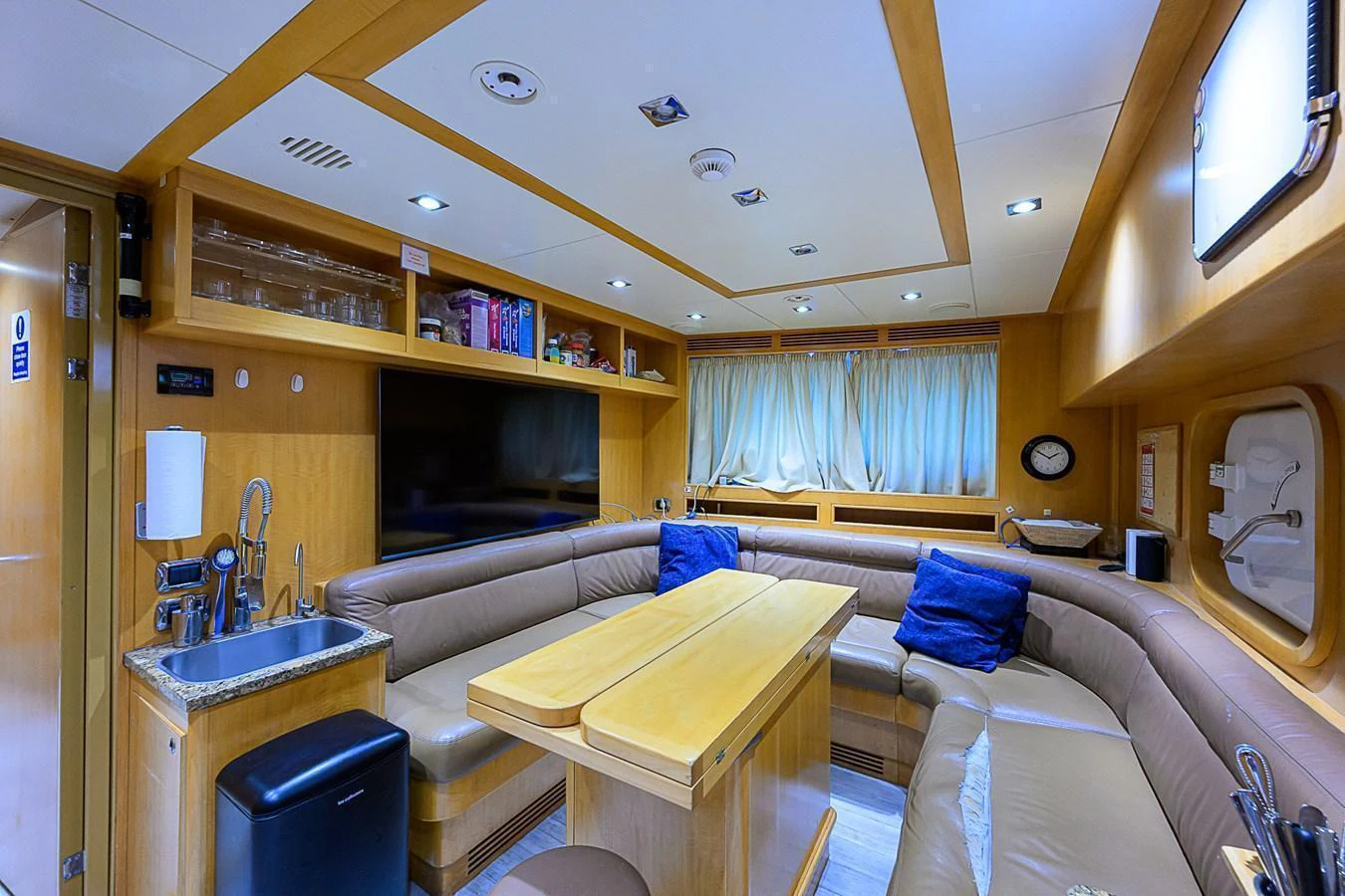 The saloon features a cozy seating area with a central table, perfect for relaxation and socializing. aboard SEASCAPE V Yacht for Sale
