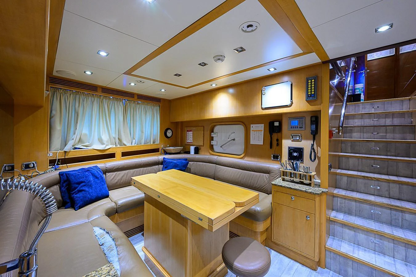 The saloon features a cozy seating area with a central table and modern amenities. aboard SEASCAPE V Yacht for Sale