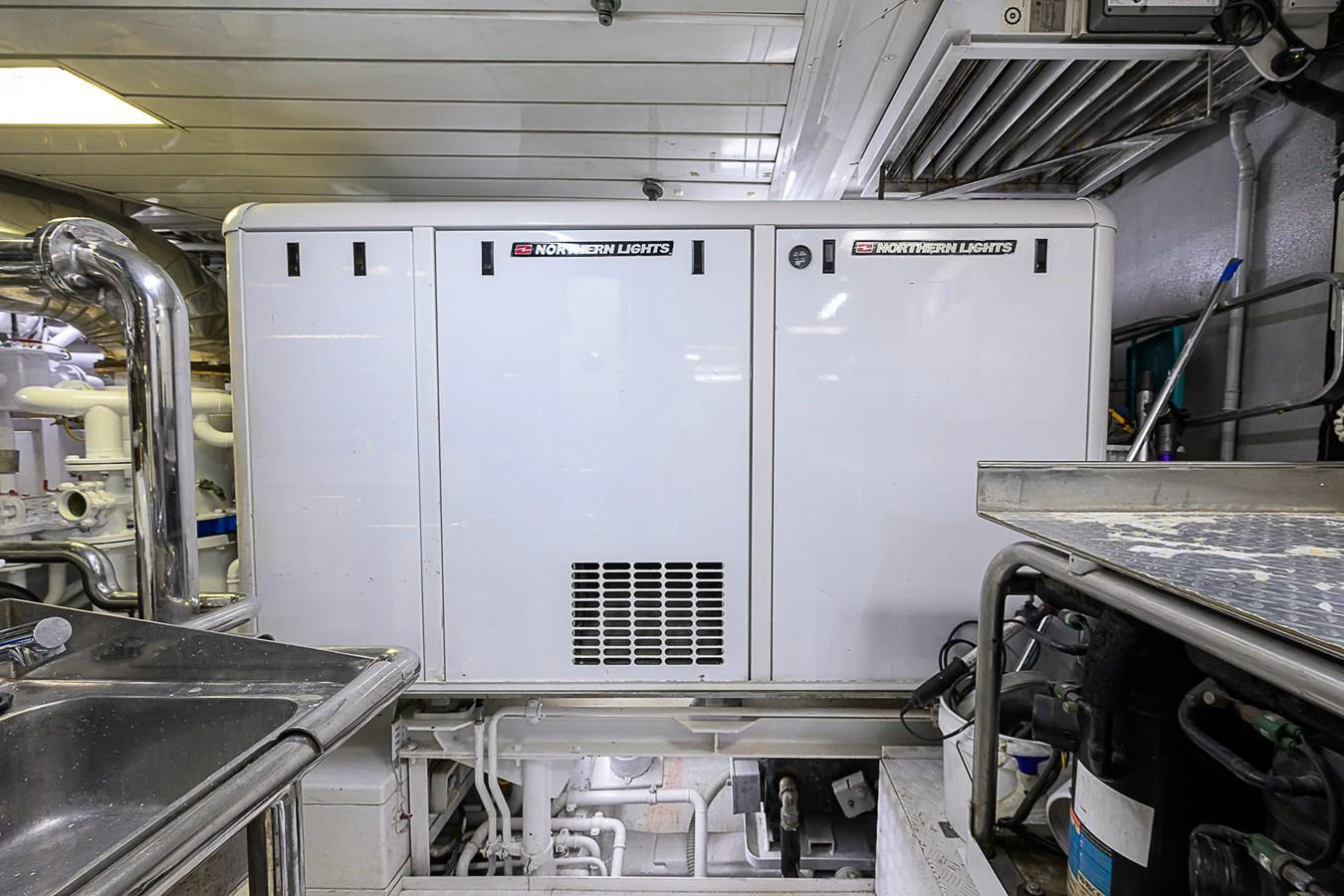 The image showcases the engine room featuring a Northern Lights generator. aboard SEASCAPE V Yacht for Sale
