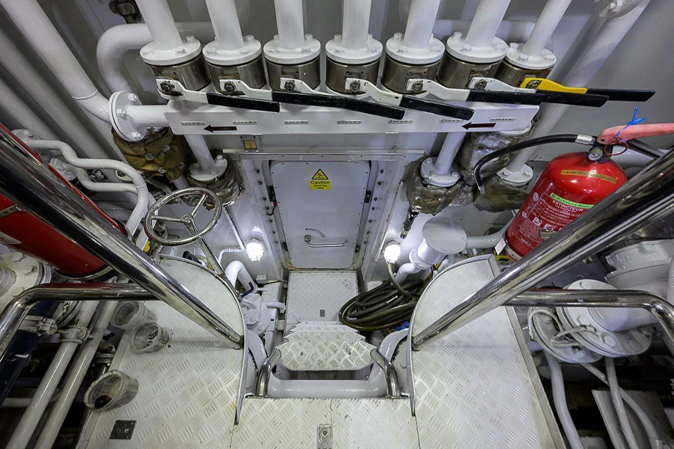 The image showcases the yacht's engine room with various mechanical components and safety equipment. aboard SEASCAPE V Yacht for Sale