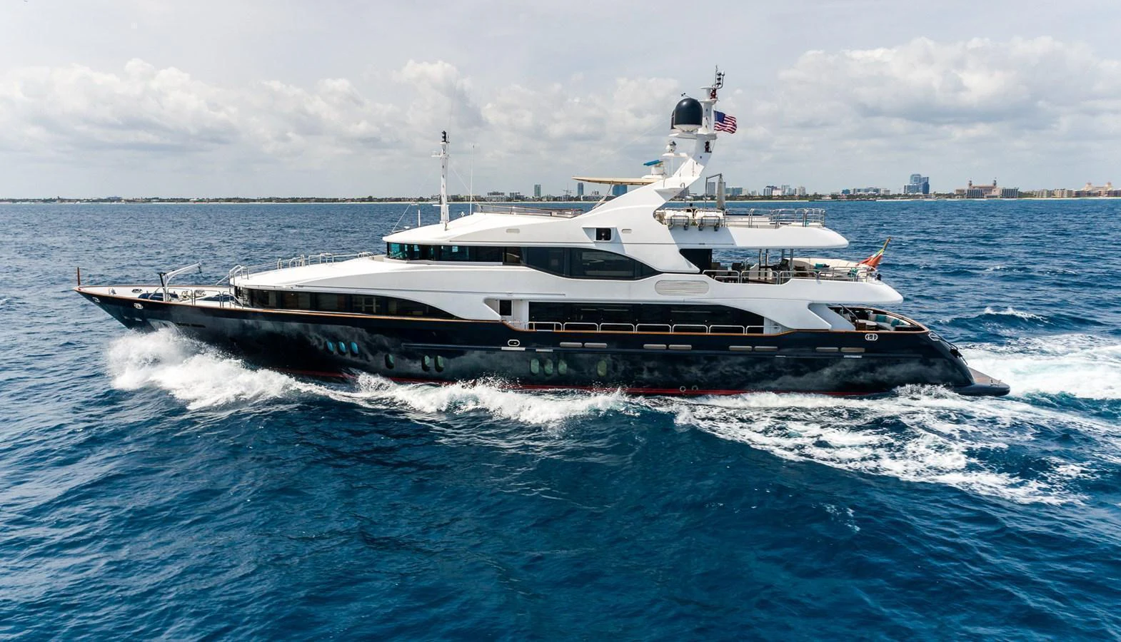 A sleek and luxurious yacht cruises through the open sea, showcasing its elegant design and spacious decks. aboard SEASCAPE V Yacht for Sale