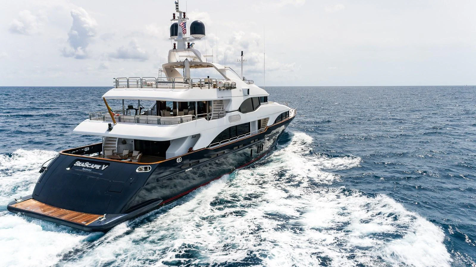 A sleek and modern yacht cruising through open waters, showcasing its elegant design and spacious decks. aboard SEASCAPE V Yacht for Sale