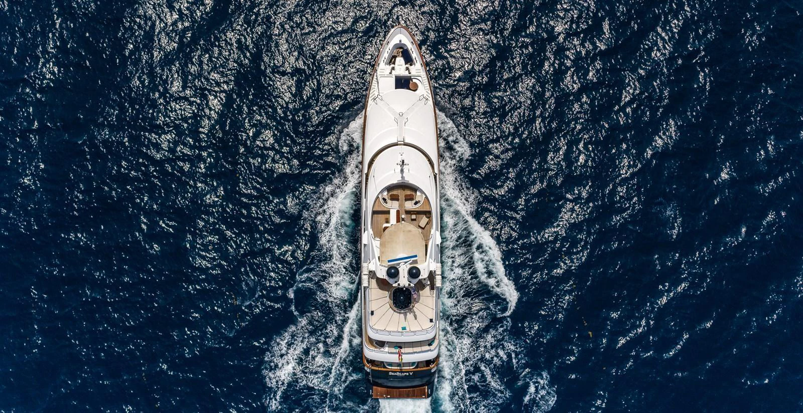 Aerial view of a luxurious yacht cruising through deep blue waters. aboard SEASCAPE V Yacht for Sale