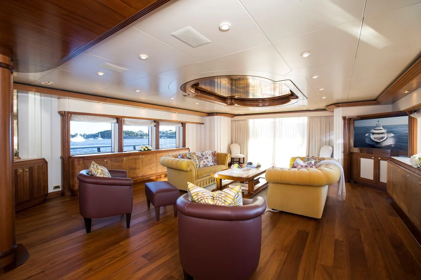 The yacht's salon features luxurious seating and elegant wood finishes, creating a warm and inviting atmosphere. aboard ALASKA OF GEORGE TOWN Yacht for Sale
