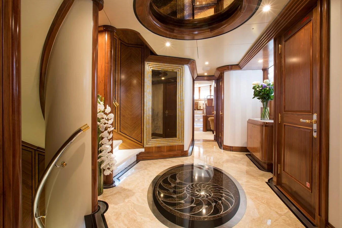 The yacht's interior features elegant wood paneling and a luxurious marble floor with intricate designs. aboard ALASKA OF GEORGE TOWN Yacht for Sale