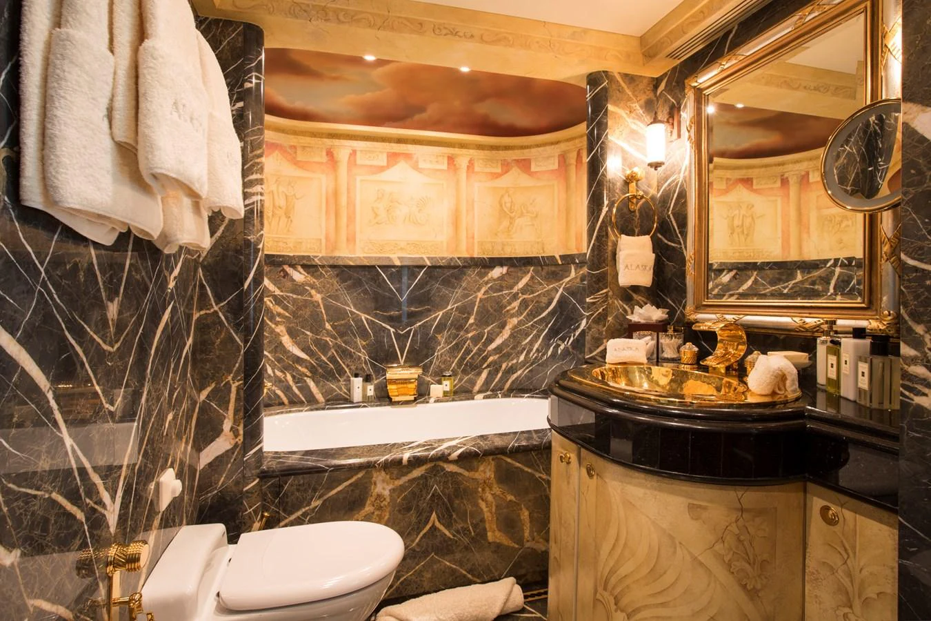 The luxurious bathroom features elegant marble finishes and gold accents. aboard ALASKA OF GEORGE TOWN Yacht for Sale