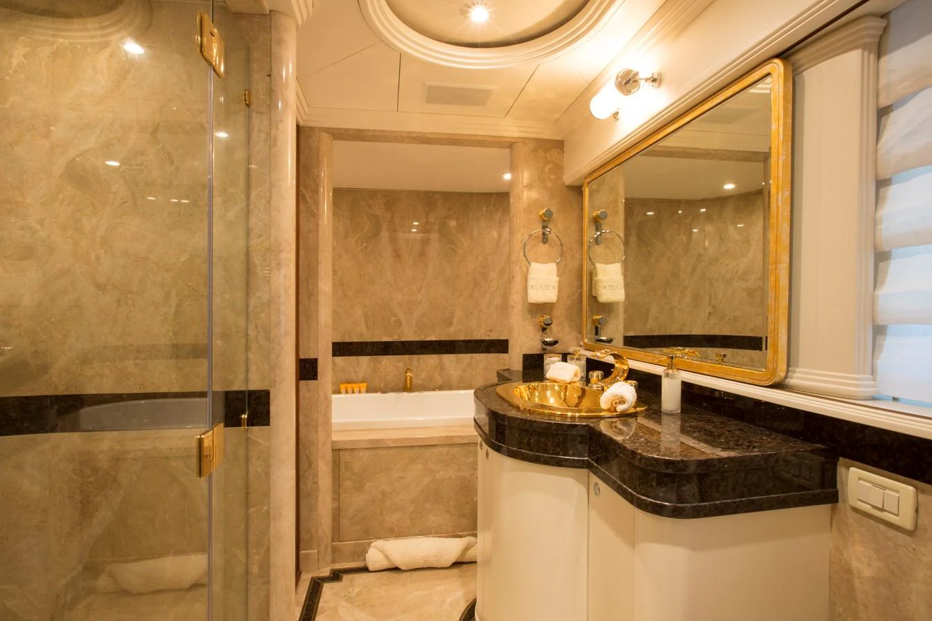 A luxurious bathroom with elegant marble finishes and gold accents. aboard ALASKA OF GEORGE TOWN Yacht for Sale