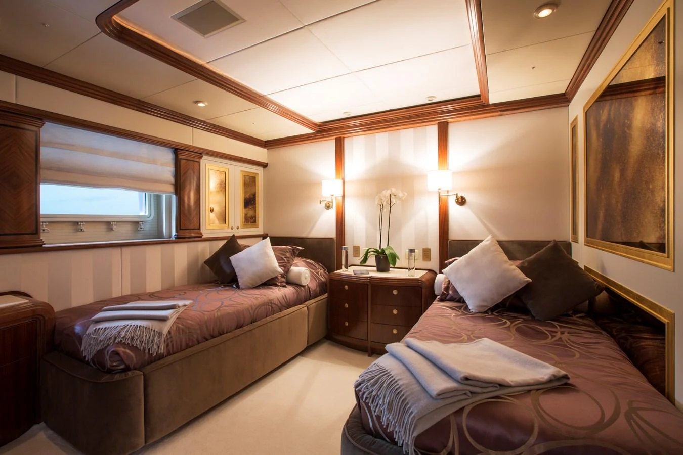 The guest stateroom features twin beds with elegant bedding and warm lighting, creating a cozy and inviting atmosphere. aboard ALASKA OF GEORGE TOWN Yacht for Sale