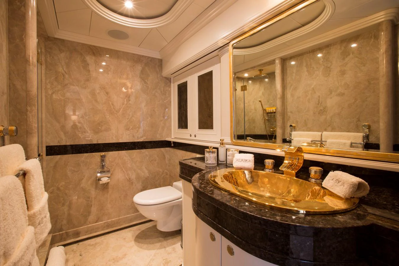 Luxurious yacht bathroom with elegant marble finishes and gold accents. aboard ALASKA OF GEORGE TOWN Yacht for Sale