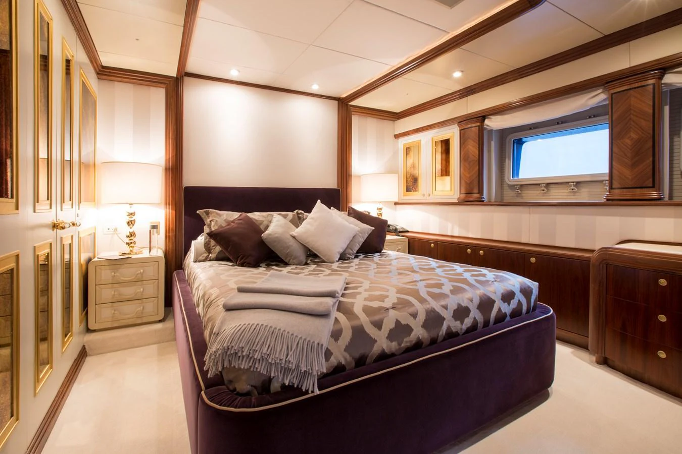 The master stateroom exudes luxury with its plush bedding, elegant wood finishes, and ambient lighting. aboard ALASKA OF GEORGE TOWN Yacht for Sale