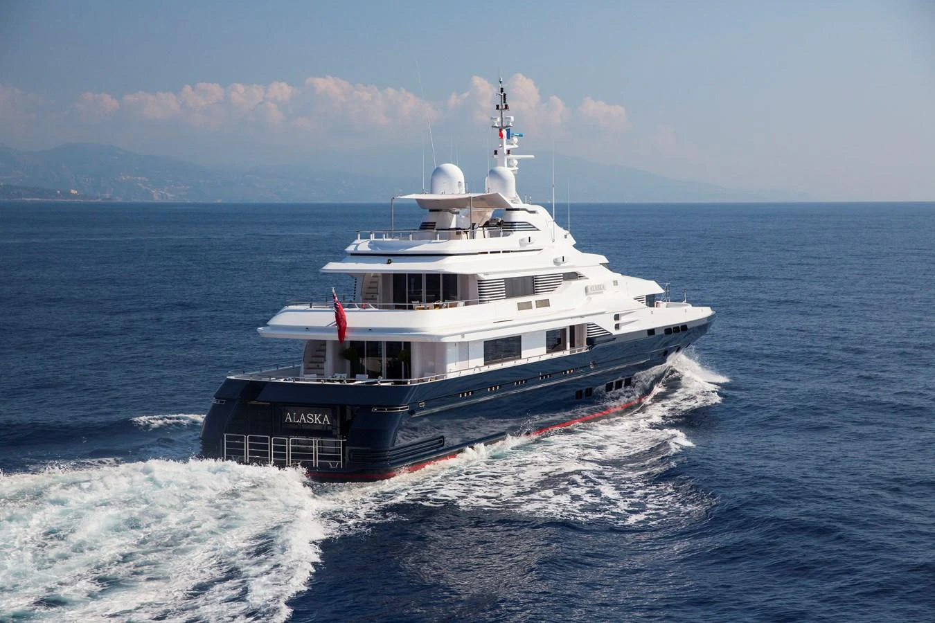 A luxurious yacht glides through the open sea, showcasing its elegant design and spacious decks. aboard ALASKA OF GEORGE TOWN Yacht for Sale